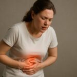 Woman holding stomach in pain