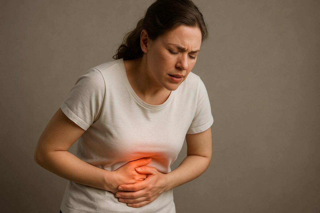 Woman holding stomach in pain