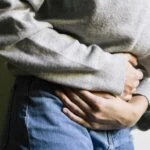 Person holding midsection with bladder pain